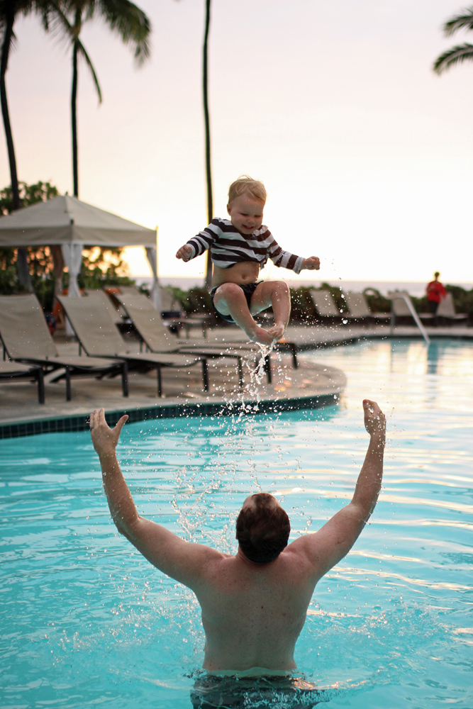 dad throwing baby in pool