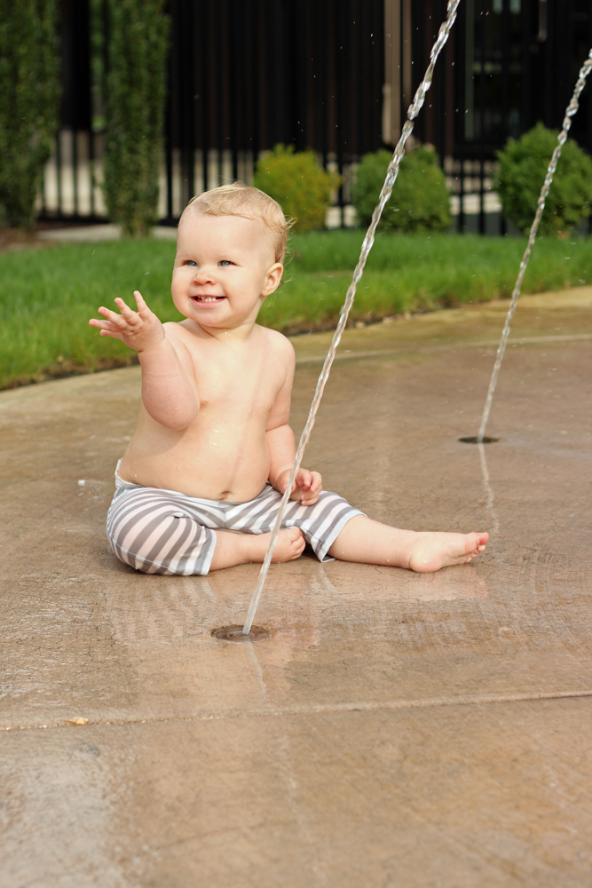 baby playing in fountain
